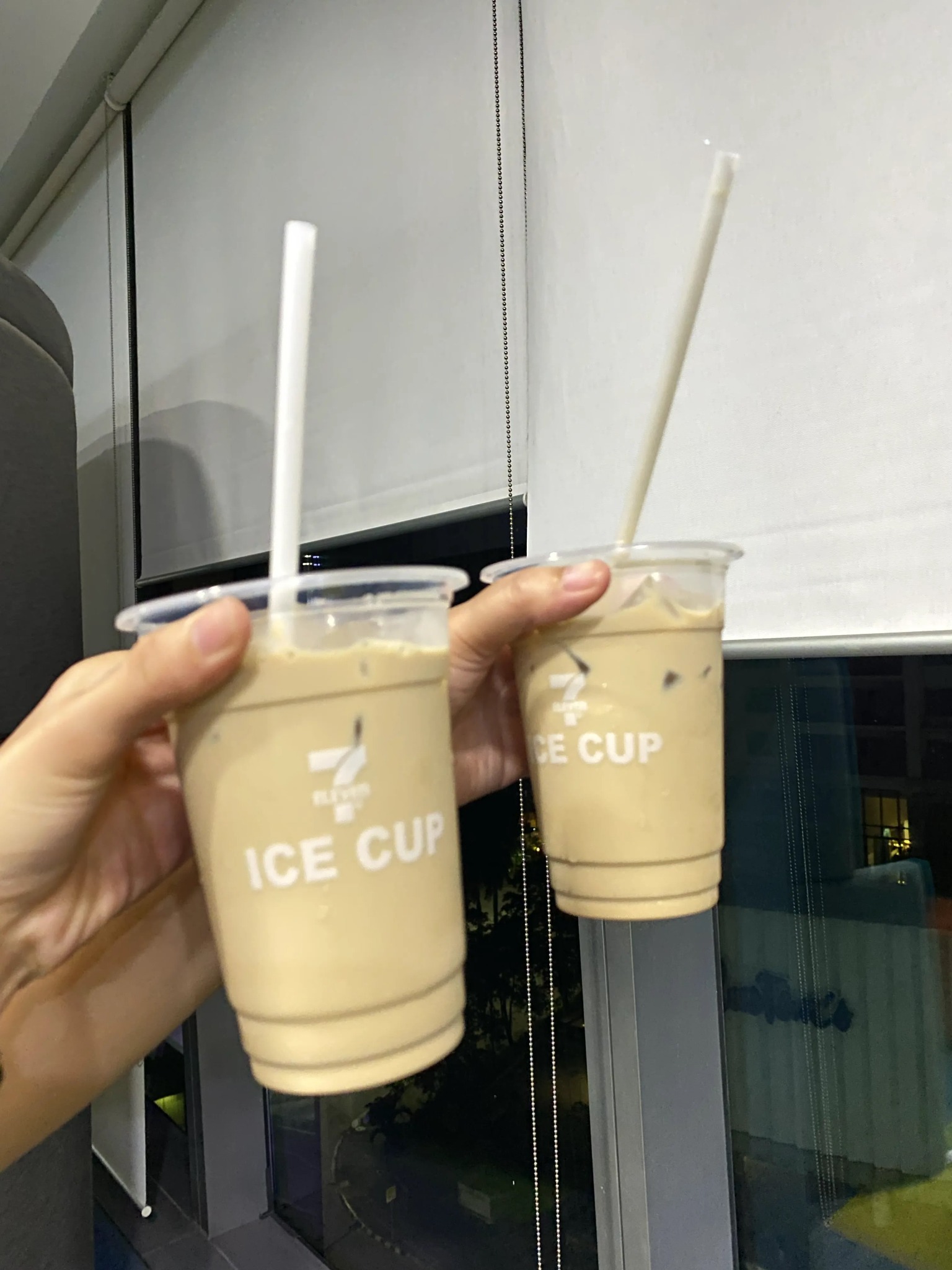 two iced drinks by a window