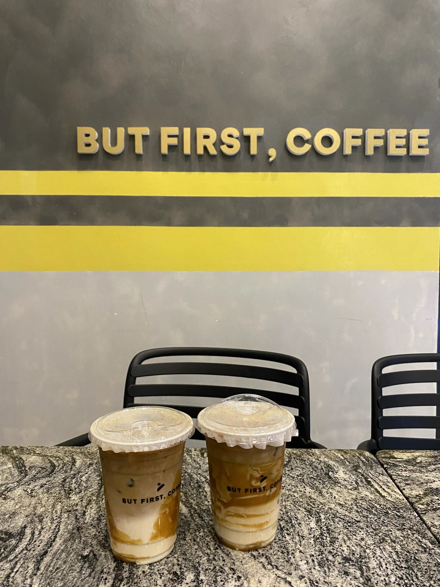two iced coffees on a cafe table